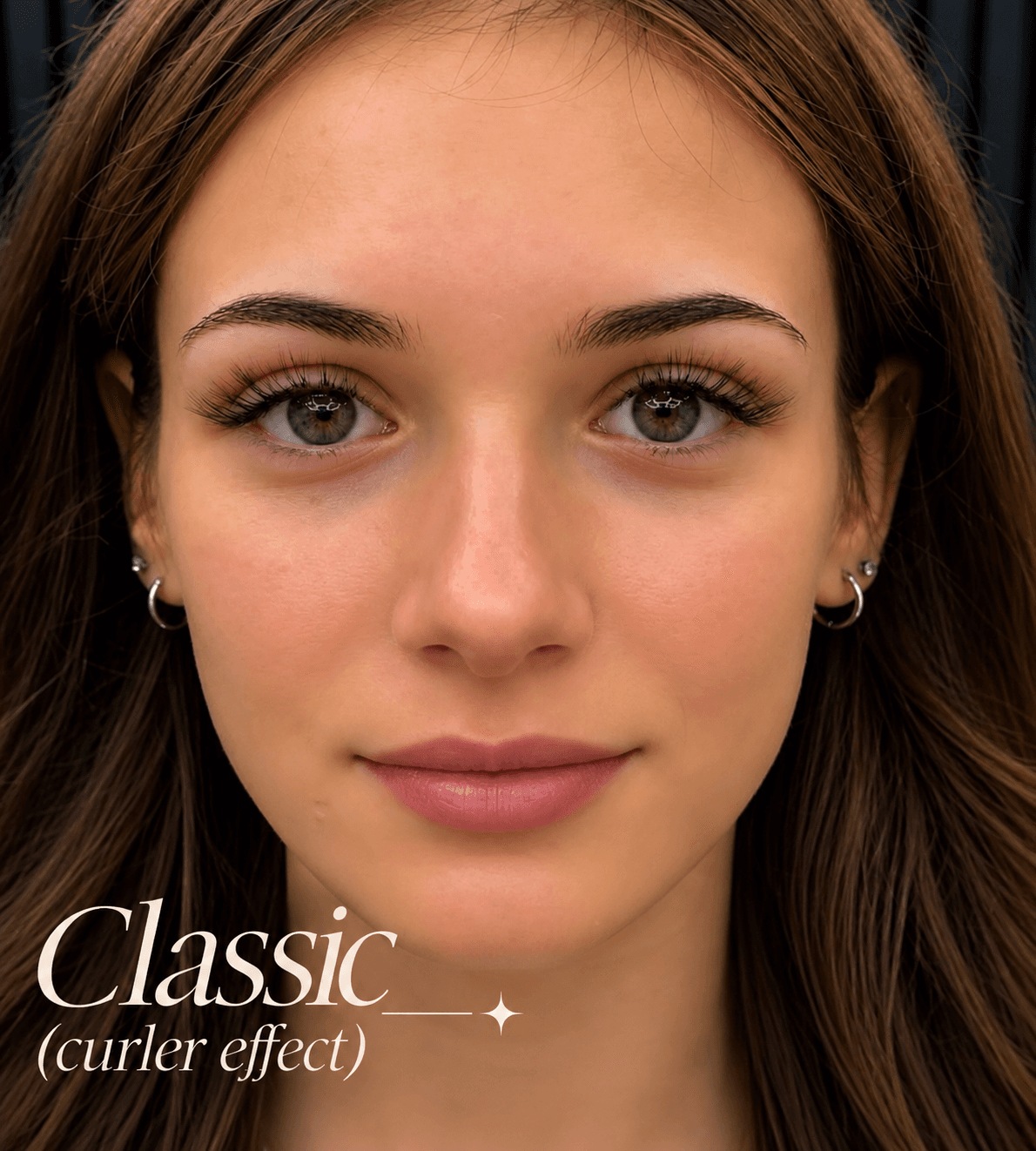 Close-up of a woman with green eyes and long eyelashes featuring a classic curler effect.