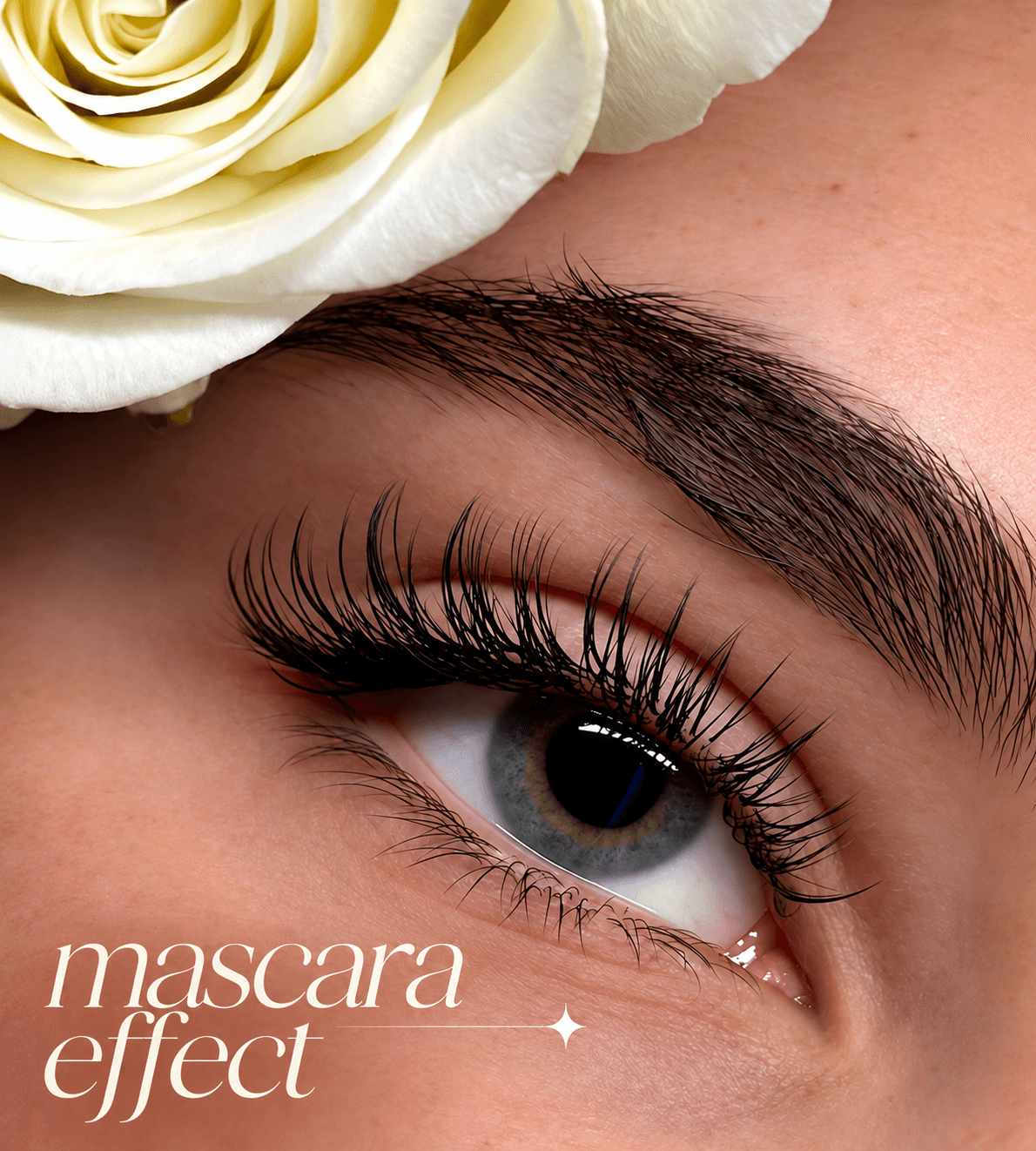 Close-up of a blue eye with long, dark eyelashes, white rose, and mascara effect text.
